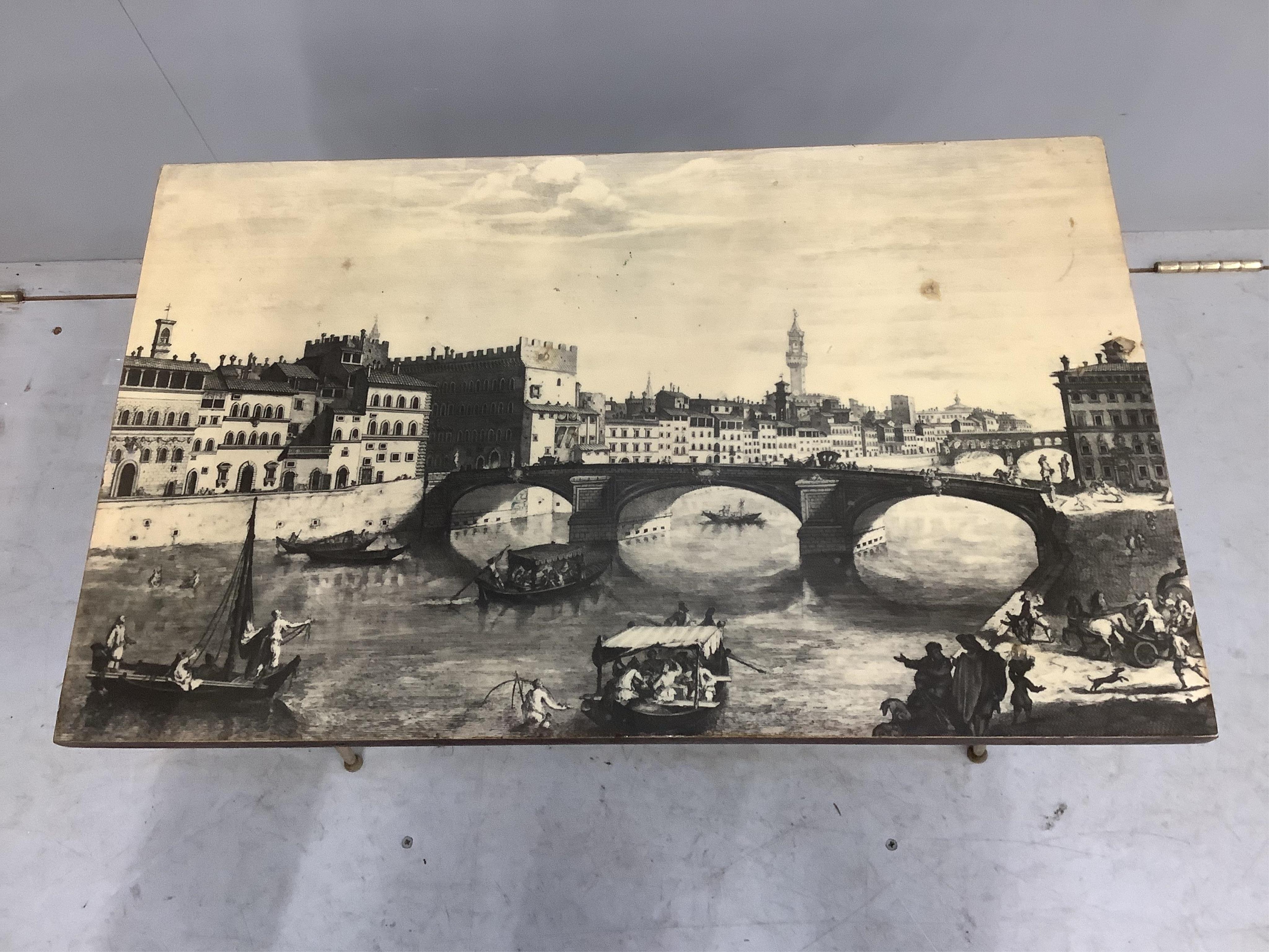 An Italian Fornasetti style rectangular coffee table, printed with a Florence canal scene, width 65cm, depth 40cm, height 43cm. Condition - fair